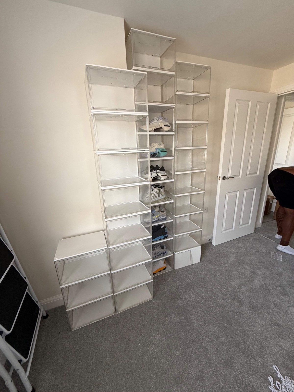 LED acrylic display box wall loaded with sneakers in a home or store setting
